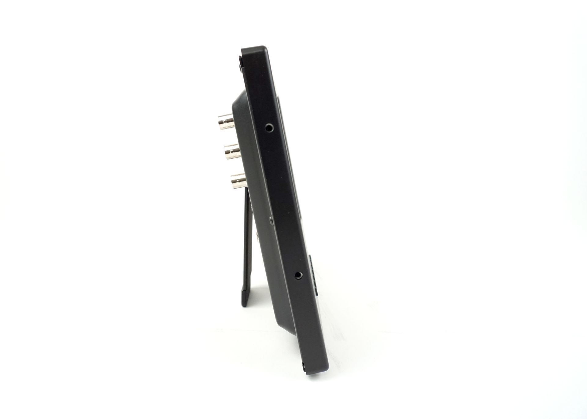 A black monitor is sitting on a white surface.