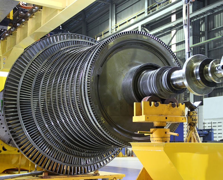 large metal object held up by yellow metal in factory
