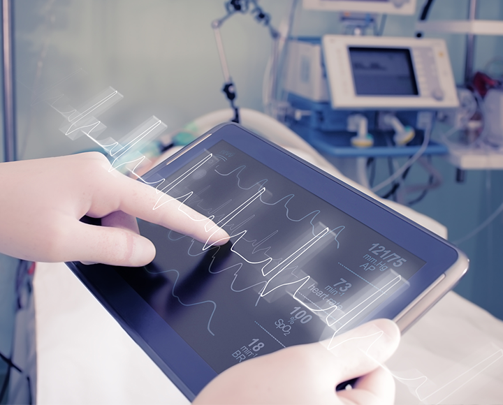 hands holding a medical tablet in hospital environment