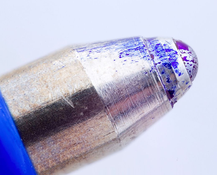 very close focus image of sliver tip with blue paint