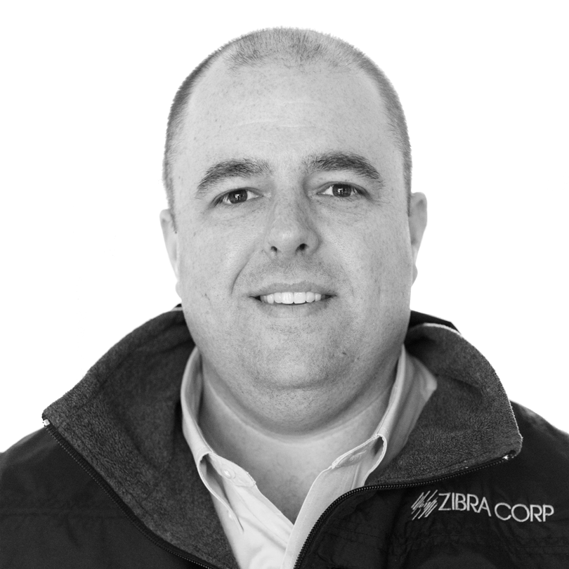 headshot of man wearing quarterzip in black and white