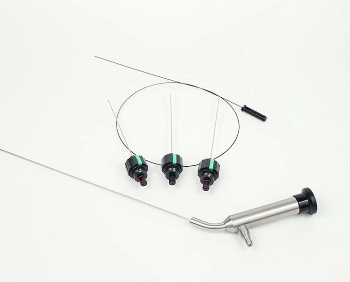 A pair of scopes and a surgical instrument on a white surface