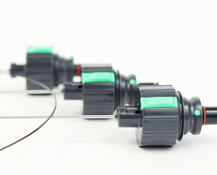 A row of black and green connectors on a white surface