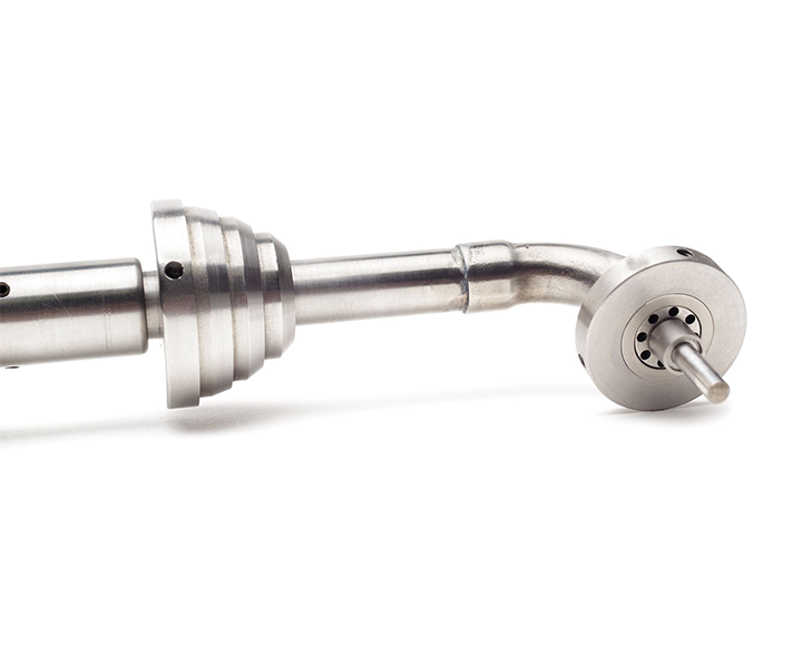 A close up of a metal object on a white background