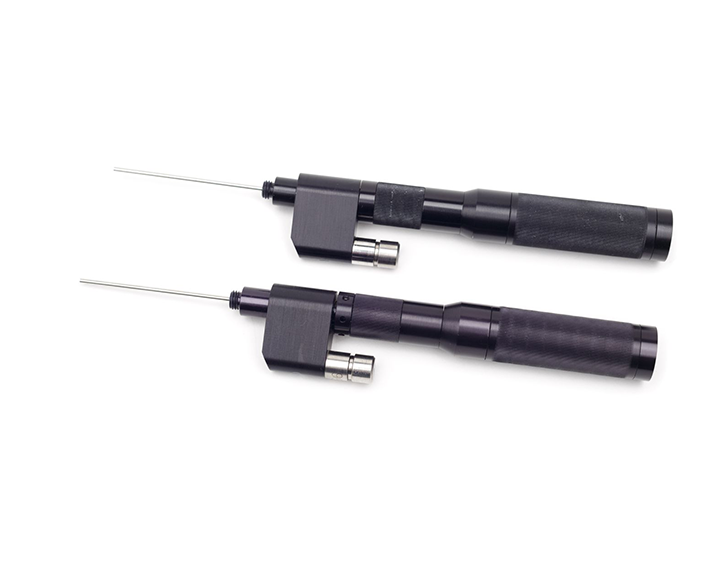 A pair of black borescopes on a white background.