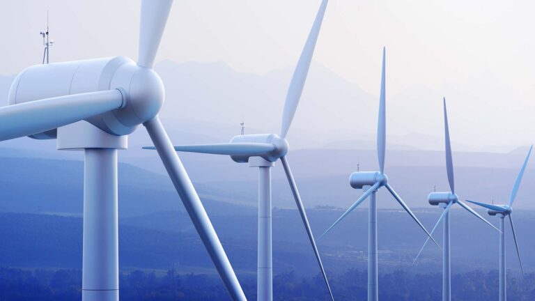 Wind turbines with a mountain range in the distance