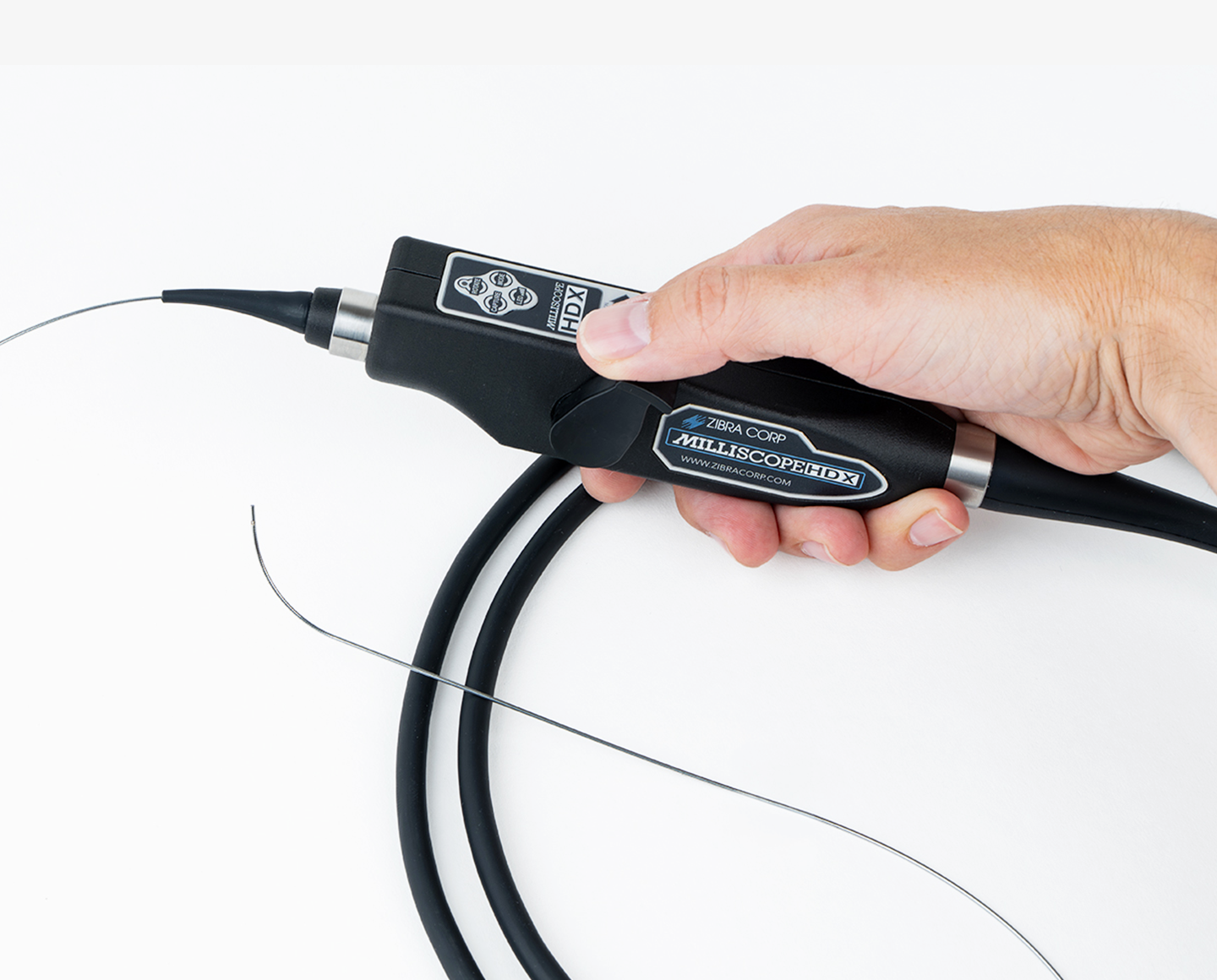 Hand holding a video borescope with the text "Milliscope HDX"
