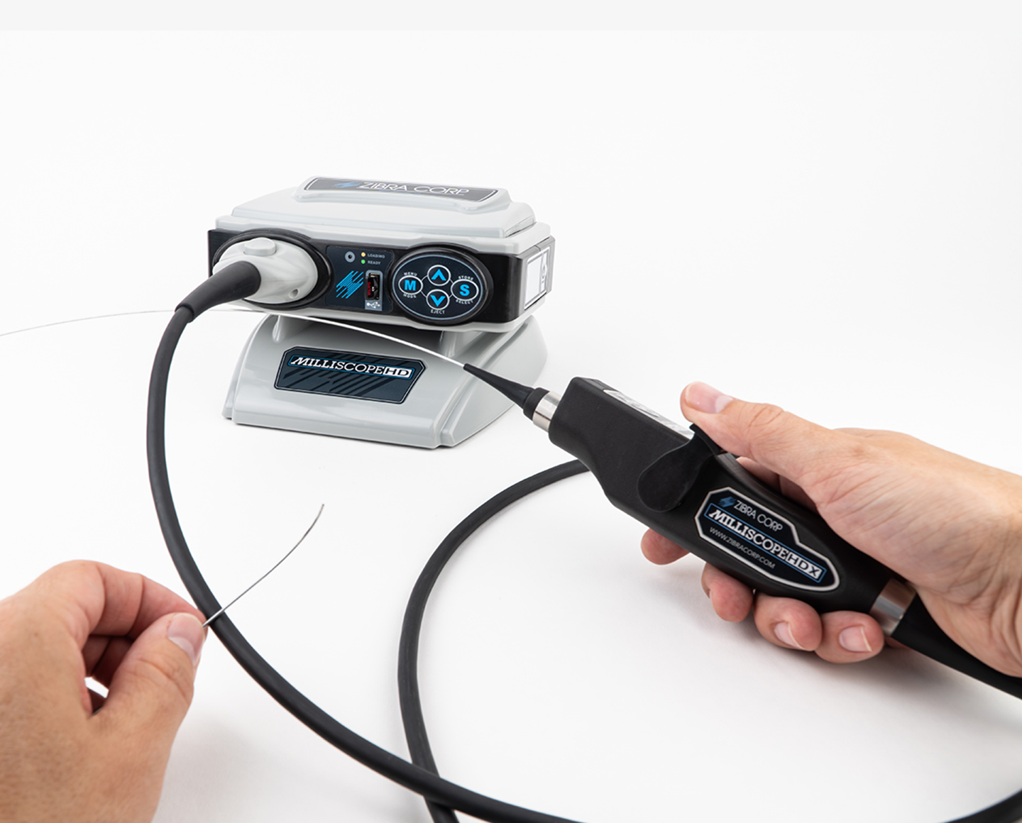 Borescope platform with hands holding a borescope tool with the text "Milliscope HDX"