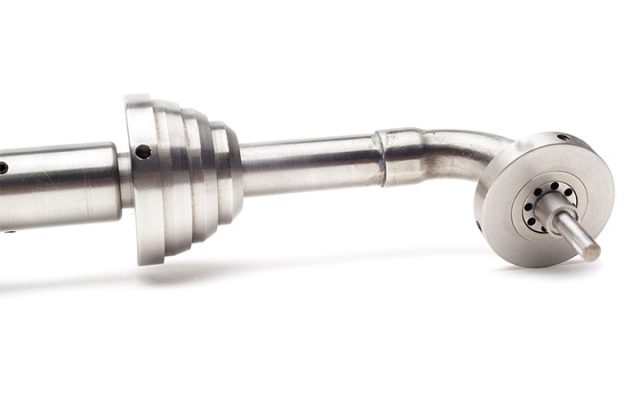 A close up of a metal object on a white background